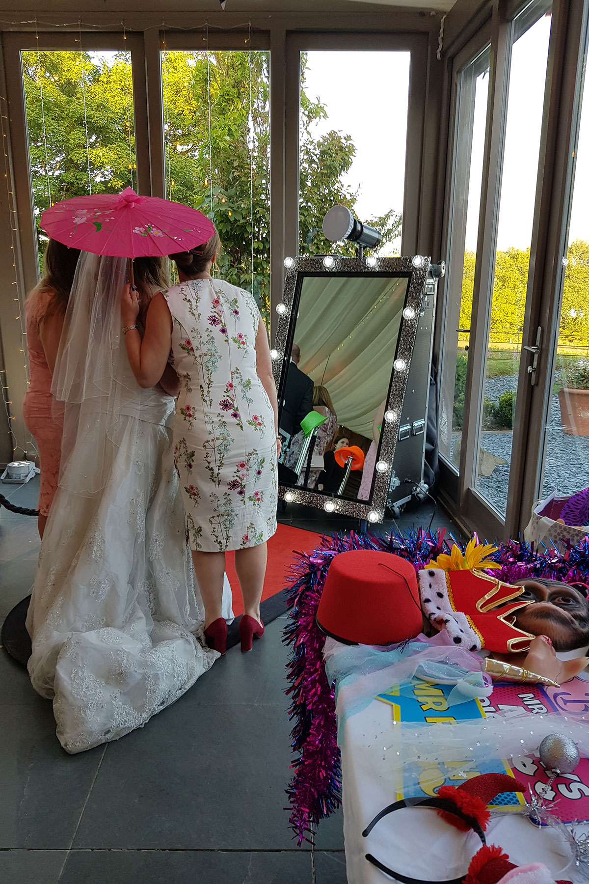 See bride using the magic mirror booth at her wedding