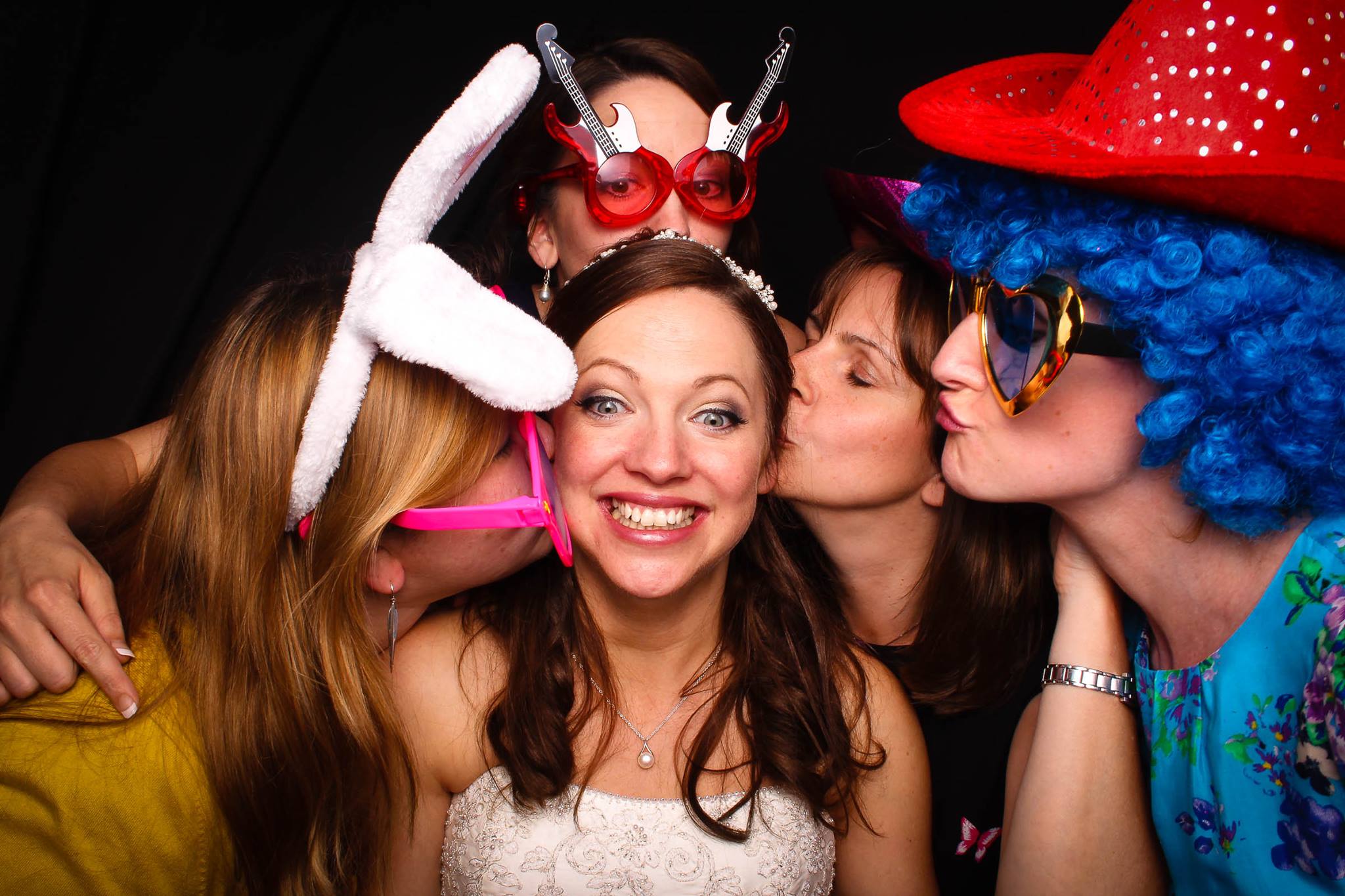 Lovely Bride surrounded by with guests in the photo booth